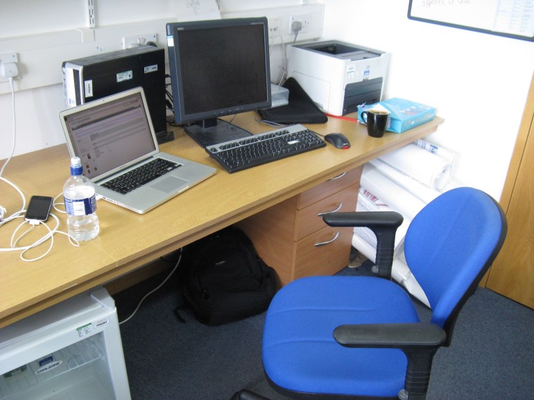 The desk space assigned to me at the Sanger Institute. Anyone opening the door too hard invariably knocked into the chair.